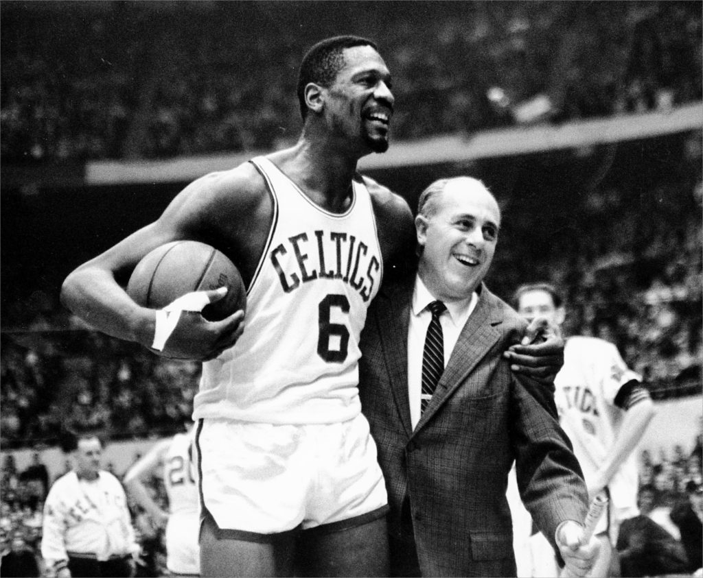 FROM MERLIN ARCHIVE, DON NOT RESEND TO LIBRARY ** FILE ** Bill Russell, left, star of the Boston Celtics is congratulated by coach Arnold "Red" Auerbach after scoring his 10,000th point in the NBA game against the Baltimore Bullets in Boston Garden in a Dec. 12, 1964, photo.  Auerbach, who coached the Boston Celtics to nine championships in the 1950s and 1960s, died Saturday, Oct. 28, 2006. He was 89. (AP Photo/file)  23red